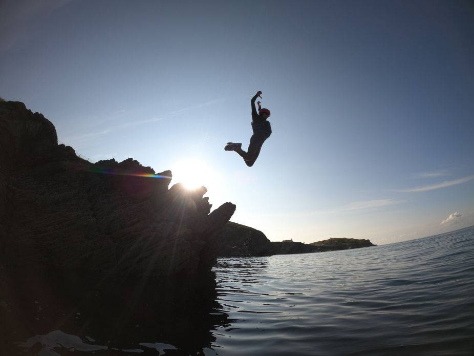 Man jumping off cliff