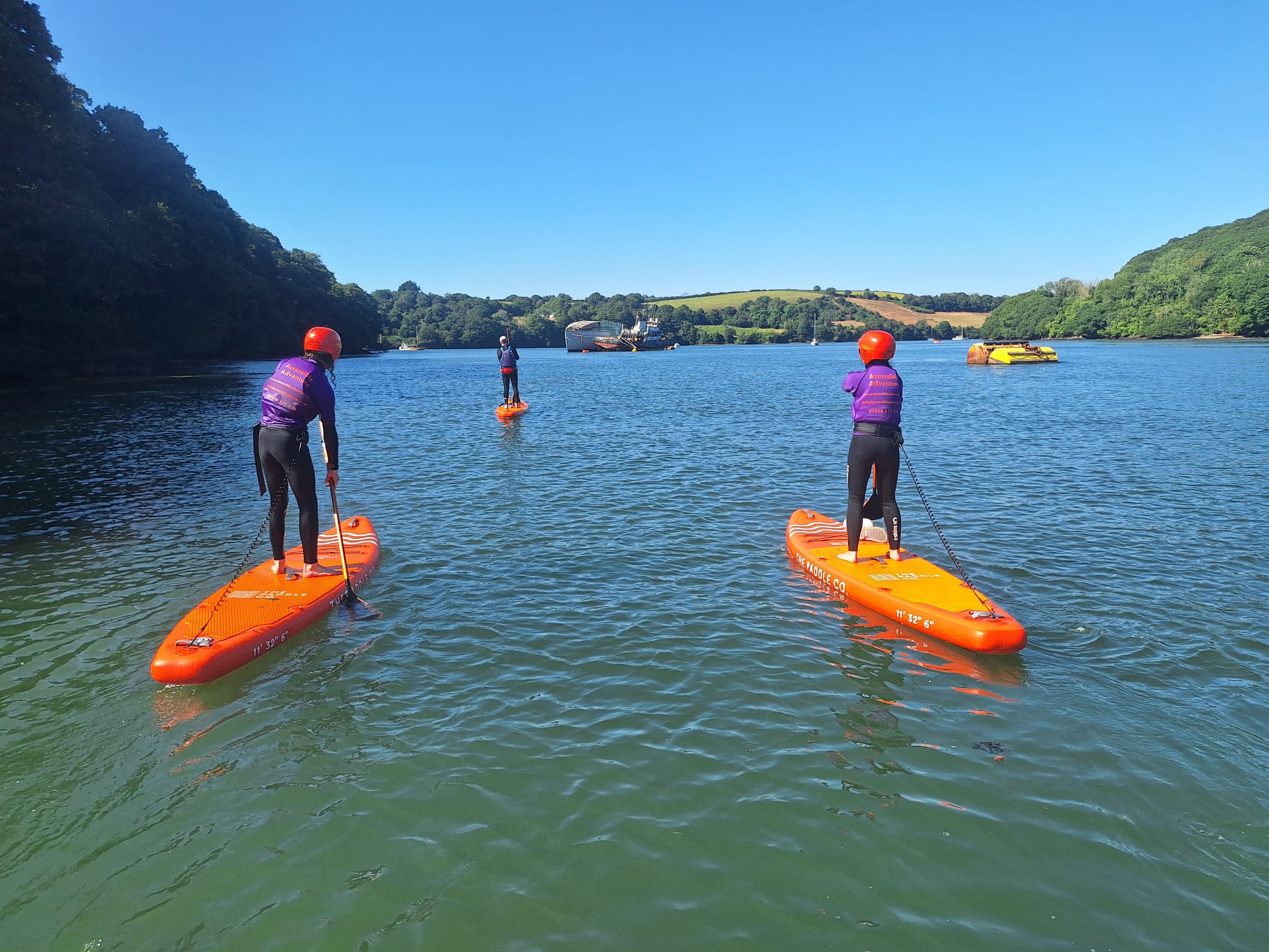 People paddleboarding on a river